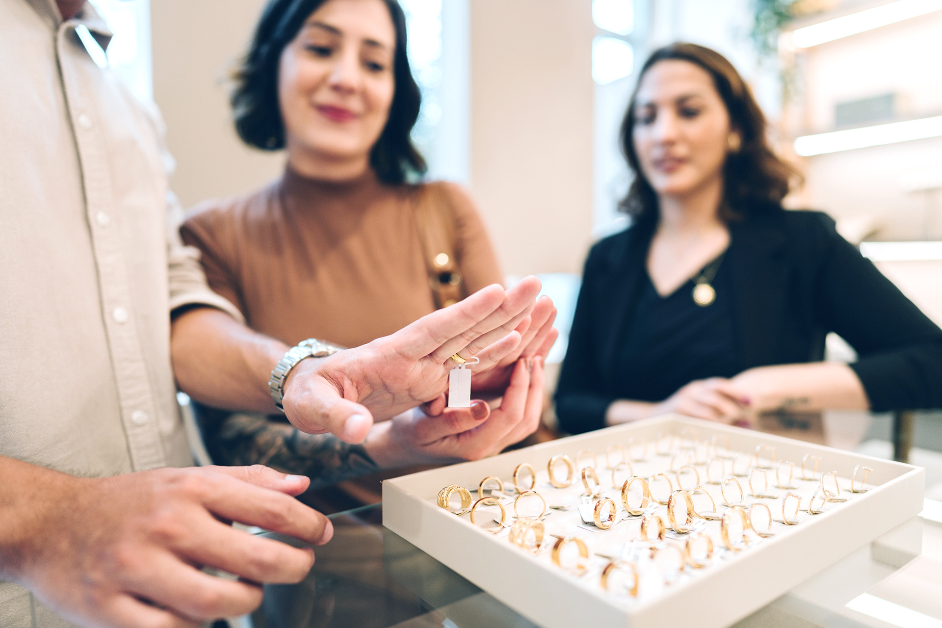 Close up of a man trying a ring on jewelry store