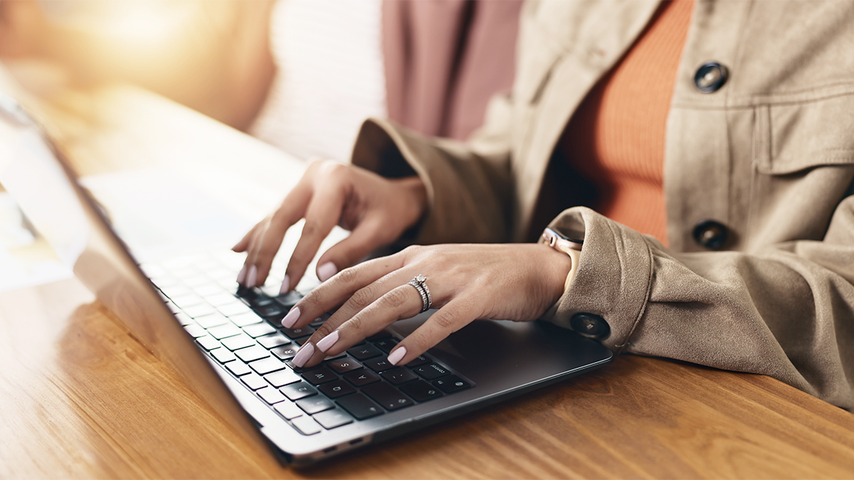 Laptop, hands and businesswoman in office with communication, email or contact for investment. Technology, typing and female financial manager with computer for online finance report in workplace.